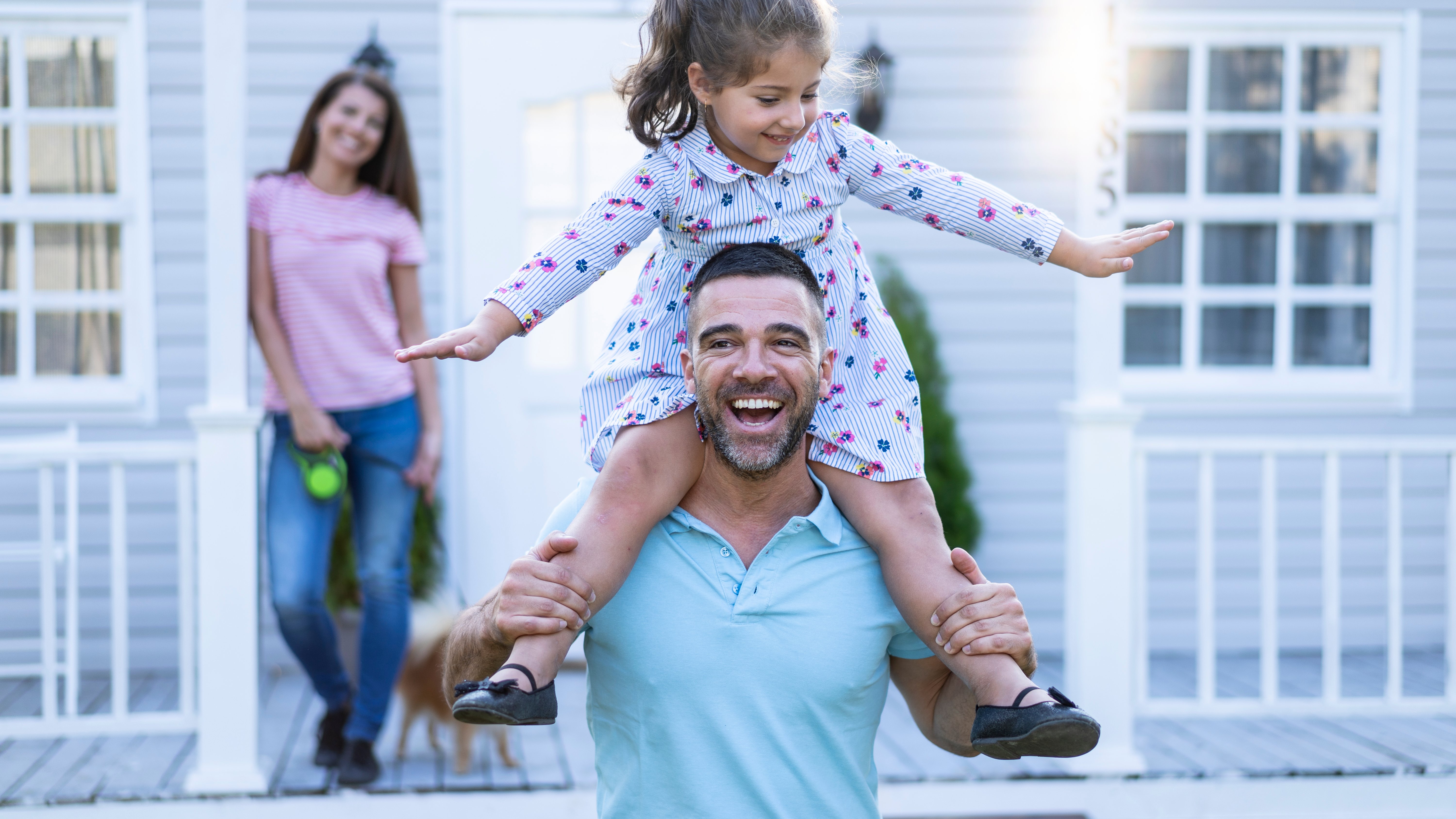 family in front of house